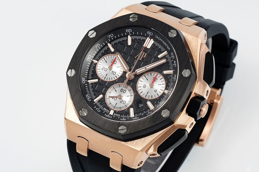 Audemars Piguet watch angled front, black dial, rose-gold case, black rubber strap.