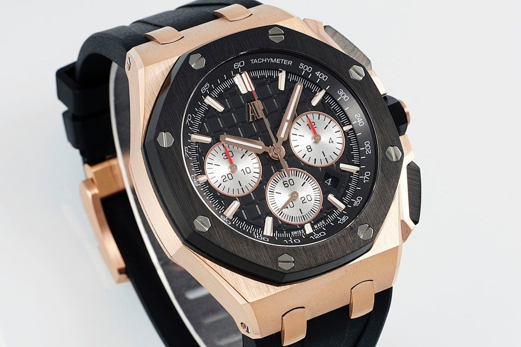 Audemars Piguet watch angled front view, black dial with white subdials, rose-gold bezel.