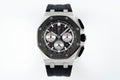 Audemars Piguet chronograph watch with black dial, three subdials, and black rubber strap