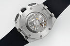Audemars Piguet watch case back with visible movement and metal bracelet on black strap
