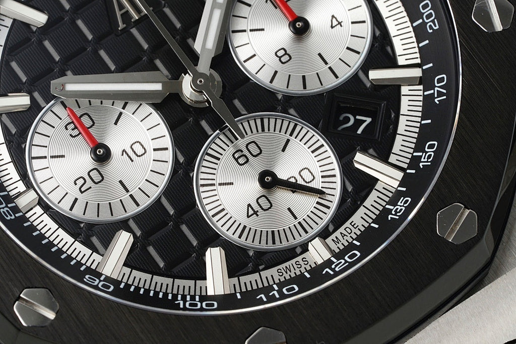 Audemars Piguet chronograph dial close-up with black subdials and red-accent hands