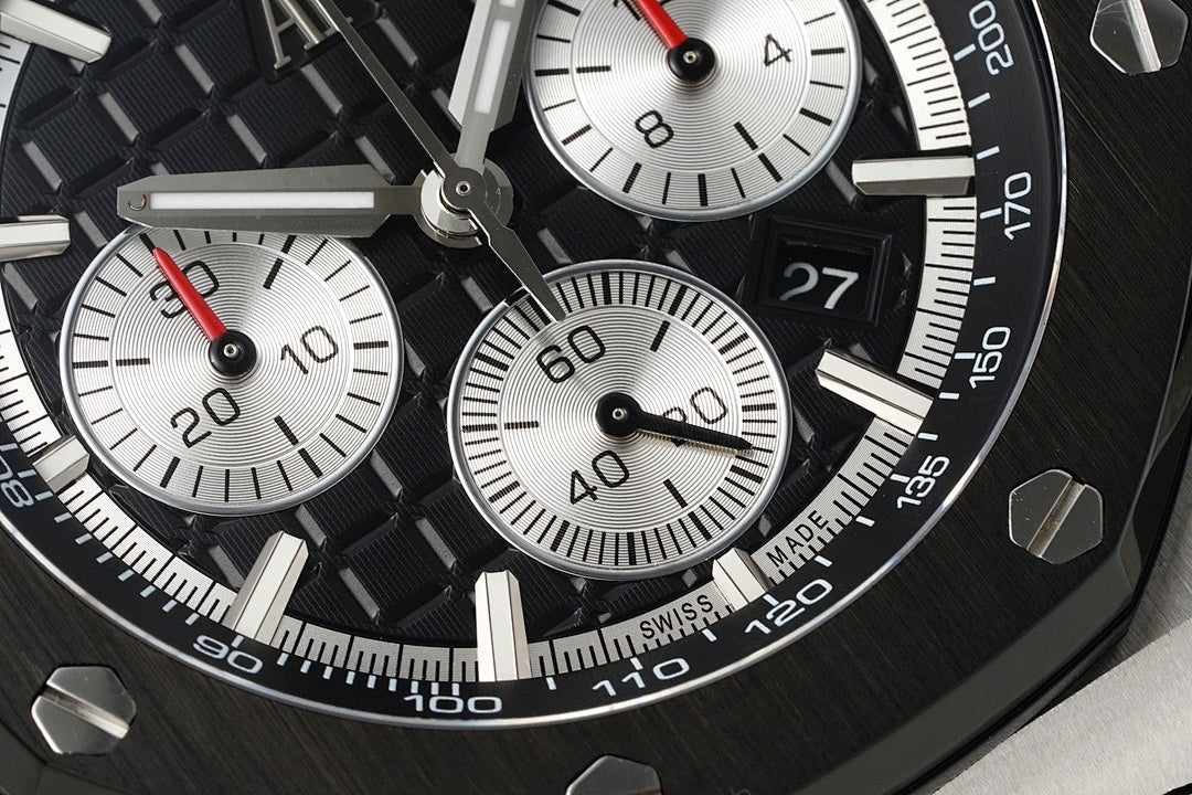 Audemars Piguet chronograph dial close-up with black subdials and red-accent hands