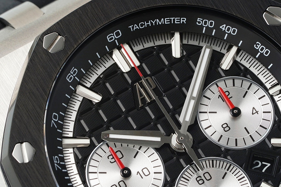 Audemars Piguet tachymeter bezel close-up with red-highlight markers and white dial subviews
