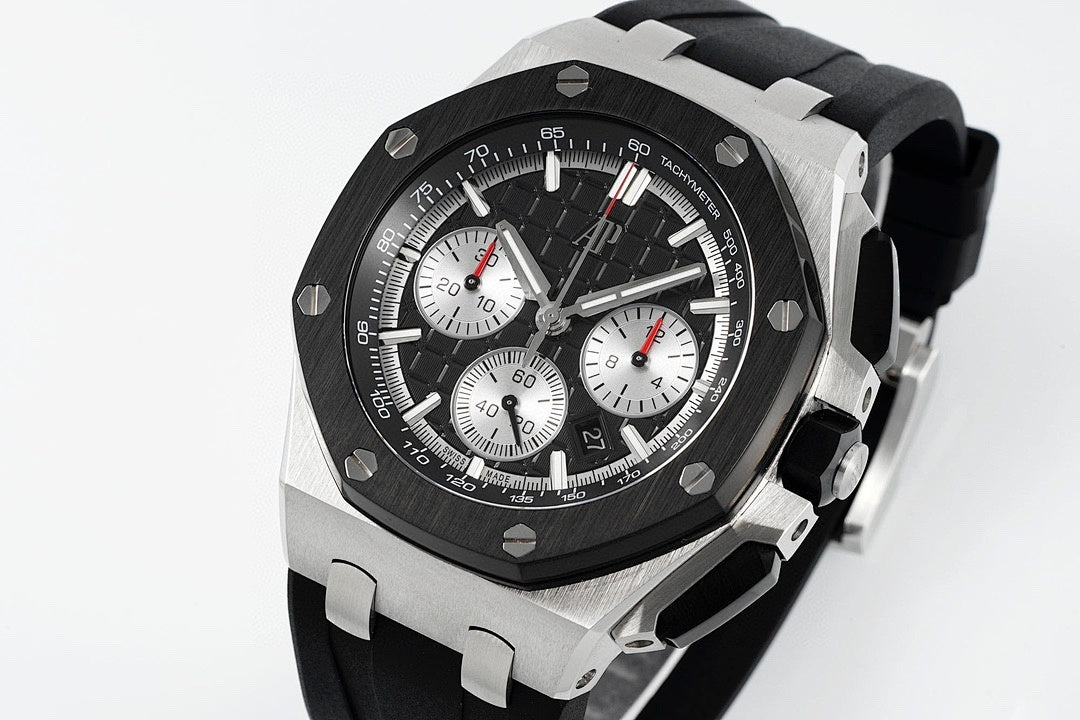 Audemars Piguet chronograph watch angled view with black dial and black rubber strap