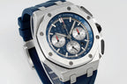 Audemars Piguet blue dial chronograph watch side view with steel bezel and blue rubber strap