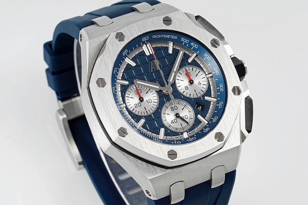 Audemars Piguet blue dial chronograph watch side view with steel bezel and blue rubber strap