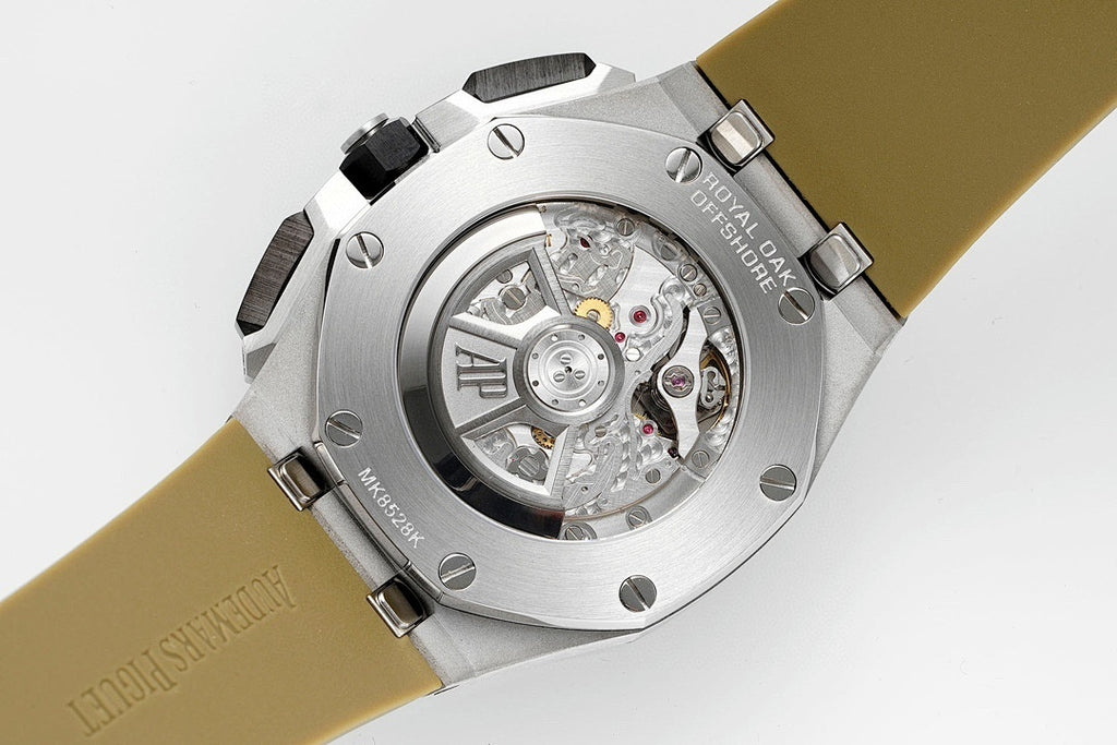 Sports watch with silver open dial, visible movement, tan strap