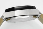 Sports watch with silver case and black bezel, close-up side view