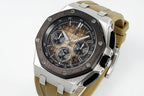 Sports watch with black dial, silver case, tan rubber strap side angle