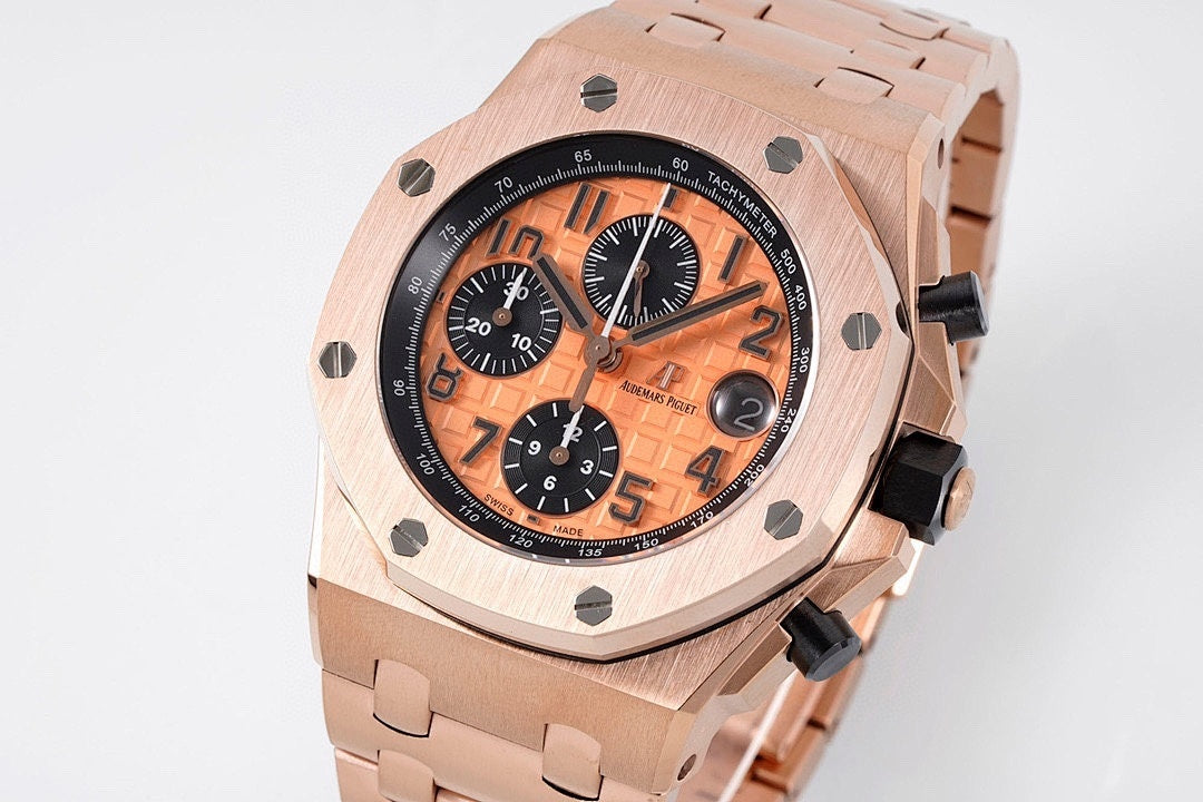 Rose gold-tone chronograph watch with orange face and black subdials on bracelet