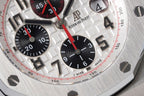 Audemars Piguet chronograph dial with black subdials and red accents on steel