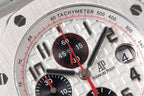 Audemars Piguet tachymeter bezel close-up with red minute markings and silver numerals