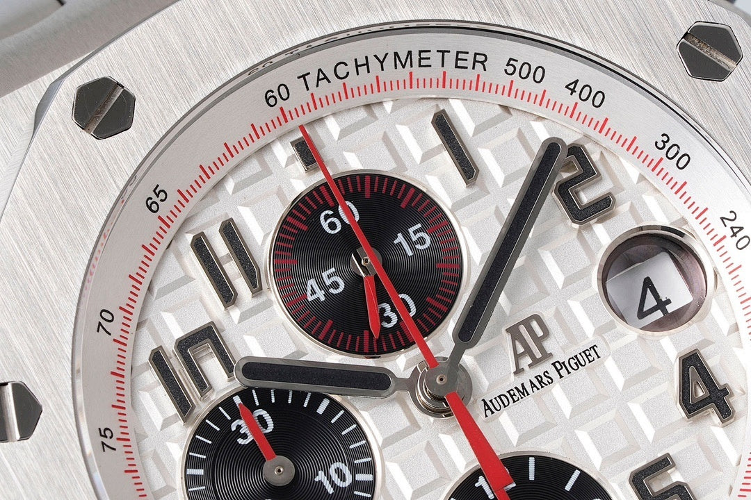Audemars Piguet tachymeter bezel close-up with red minute markings and silver numerals