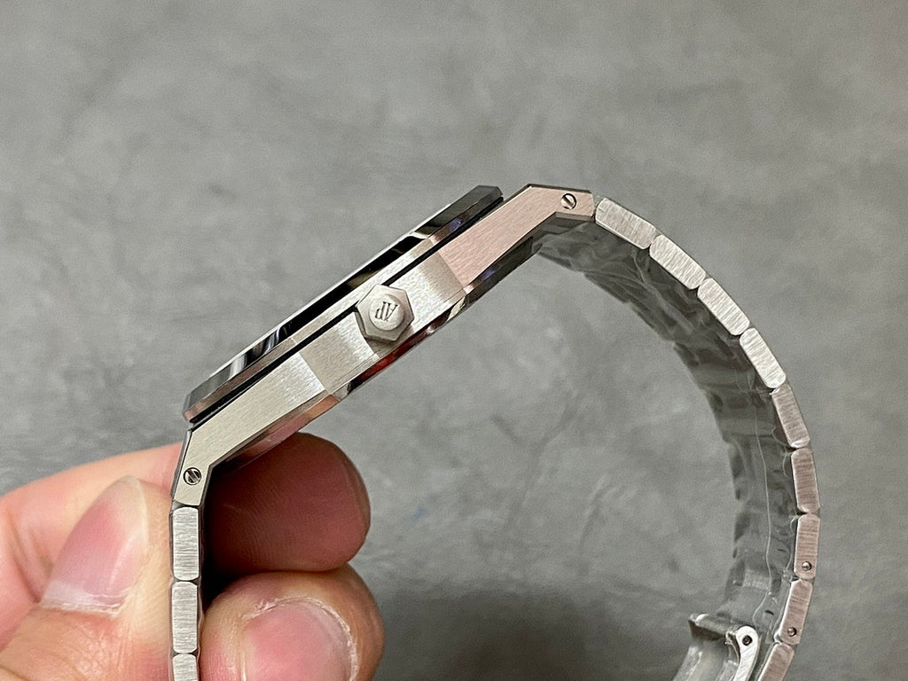 Stainless Audemars Piguet watch side view with crown and integrated bracelet