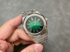Audemars Piguet watch on hand with green dial and metal bracelet