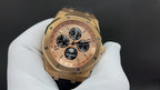 Gold-tone watch with champagne dial, multiple subdials, and black rubber strap