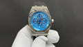 Audemars Piguet Royal Oak watch front with blue dial, steel case, black strap, three subdials