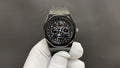 Audemars Piguet watch with black chronograph dial and metal octagonal case