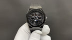 Audemars Piguet watch with black chronograph dial and metal octagonal case