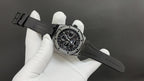 Audemars Piguet watch on black strap with metal case and chronograph dial