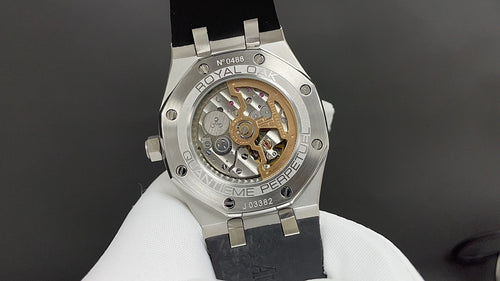 Stainless steel watch with visible movement, caseback window, and crown detail