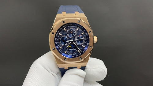 Audemars Piguet Royal Oak watch, gold case, blue dial, blue leather strap on white glove.