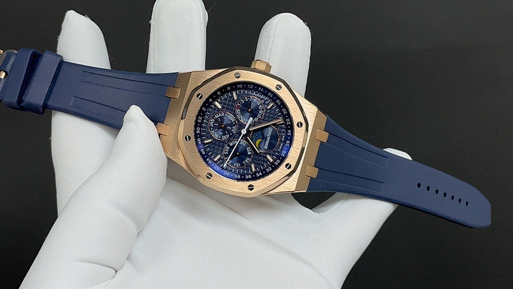 Gold Royal Oak watch front with blue strap, angled view on white glove.