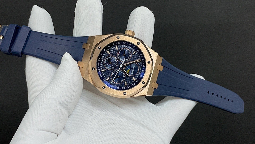 Gold Royal Oak watch front with blue strap, angled view on white glove.