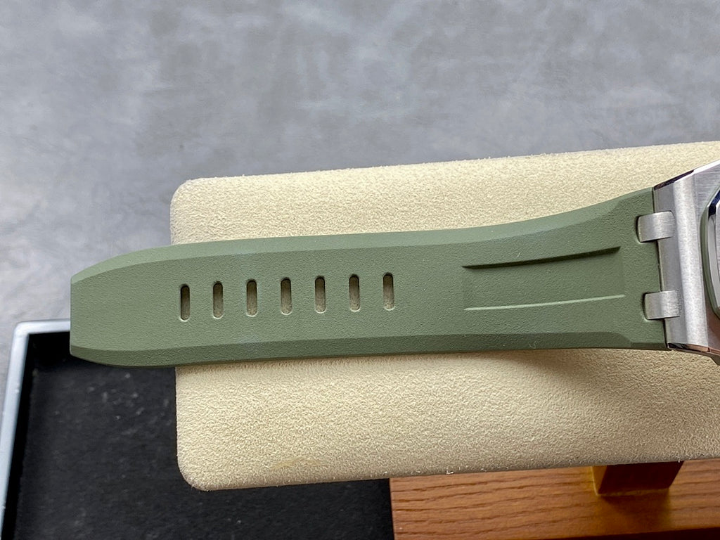 Green rubber watch strap with silver clasp and buckle, side view