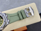 Green rubber watch strap with metal deployant clasp, angled view
