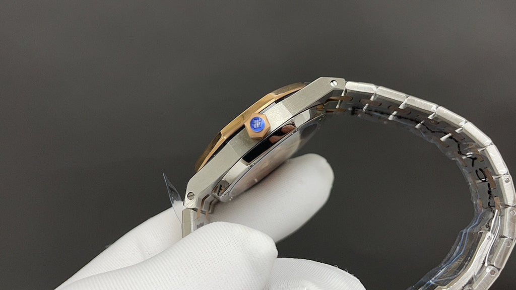 Audemars Piguet watch with blue-accent crown detail and two-tone bracelet