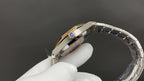 Audemars Piguet watch with blue-accent crown detail and two-tone bracelet