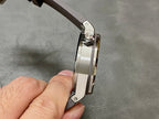 Audemars Piguet Royal Oak watch case and bezel from the side, hand holding the strap
