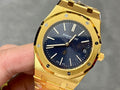 Gold-tone luxury wristwatch with blue textured dial and baton hour markers