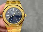 Gold-tone luxury wristwatch close-up with blue dial and date window at 5
