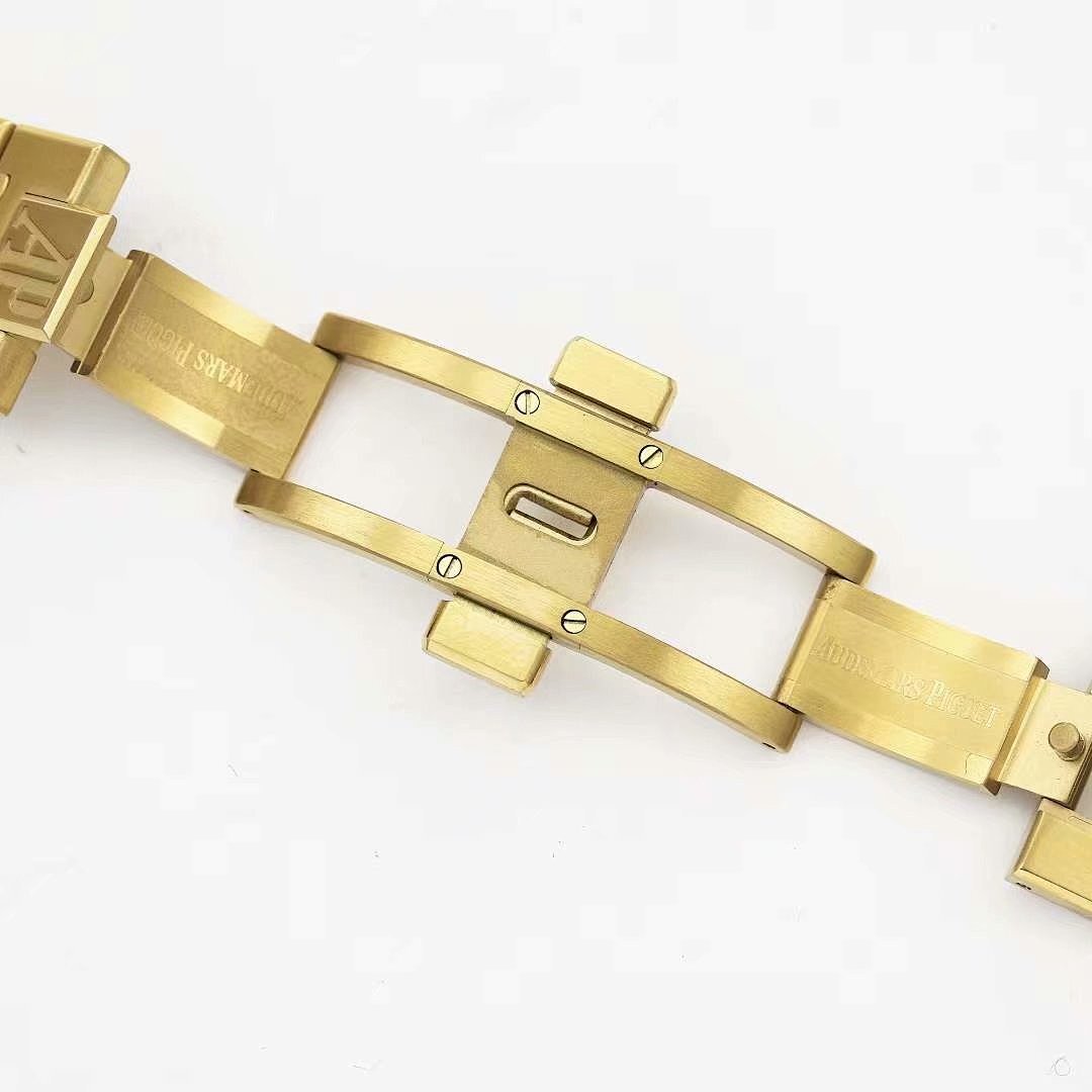 Gold metal watch bracelet with clasp and engraved links