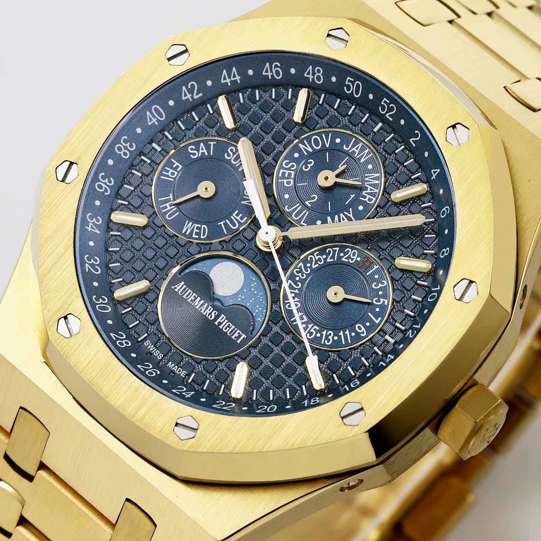 Gold-toned watch dial with day-date subdials, baton hour markers, and textured face