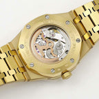 Gold-tone watch case with exposed mechanical dial view and metal bracelet links