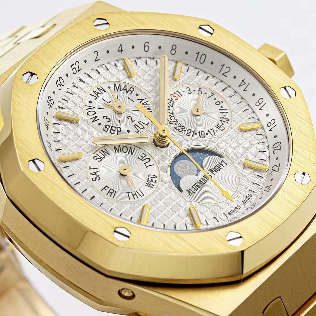 Close-up of gold-tone watch dial with day-month text rings, gold markers, and moon subdial