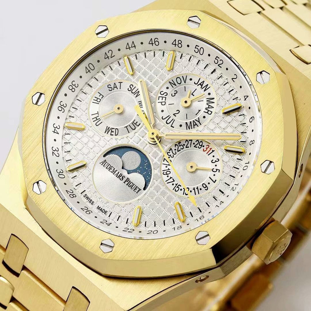 Gold-tone watch face close-up with white dial texture, gold hour markers, moonphase subdial