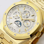 Gold-tone watch face close-up with white dial texture, gold hour markers, moonphase subdial