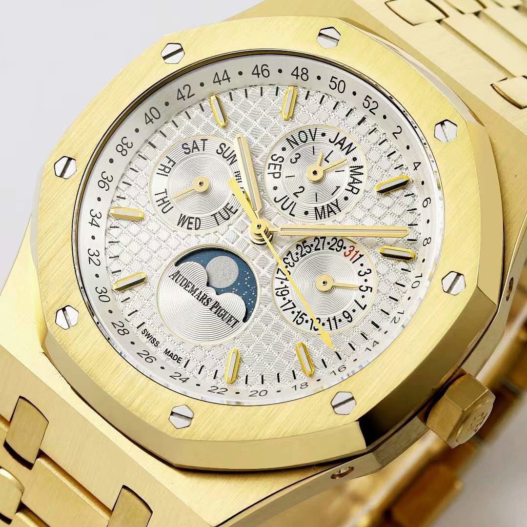 Gold-tone watch face close-up with white dial texture, gold hour markers, moonphase subdial