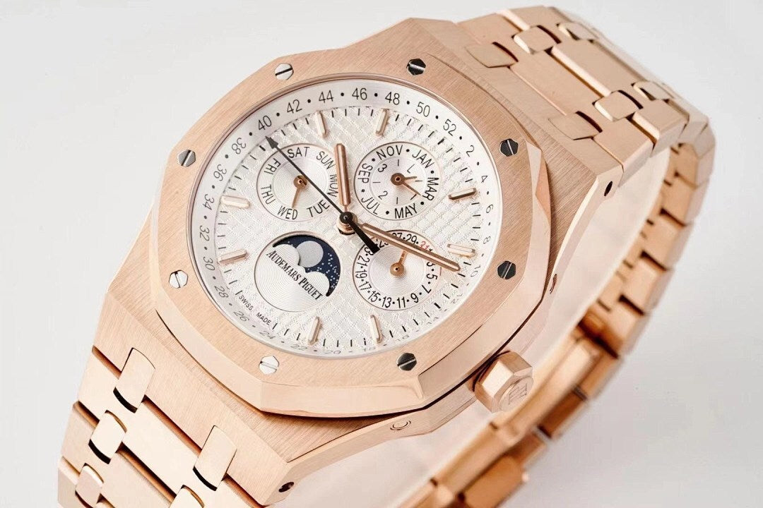 Rose gold wristwatch with white dial, subdials, and calendar markings