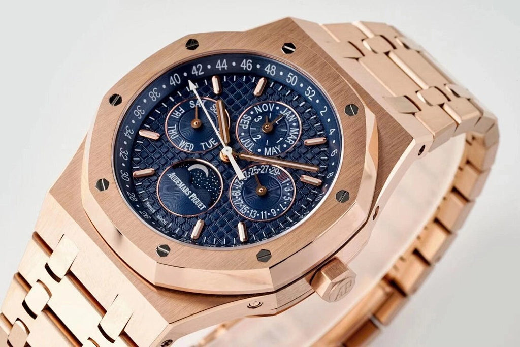 Rose gold-tone wristwatch close-up with blue dial, subdials, and date/scale markings.