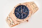 Rose gold-tone wristwatch angled view with blue dial and three round chronograph subdials.