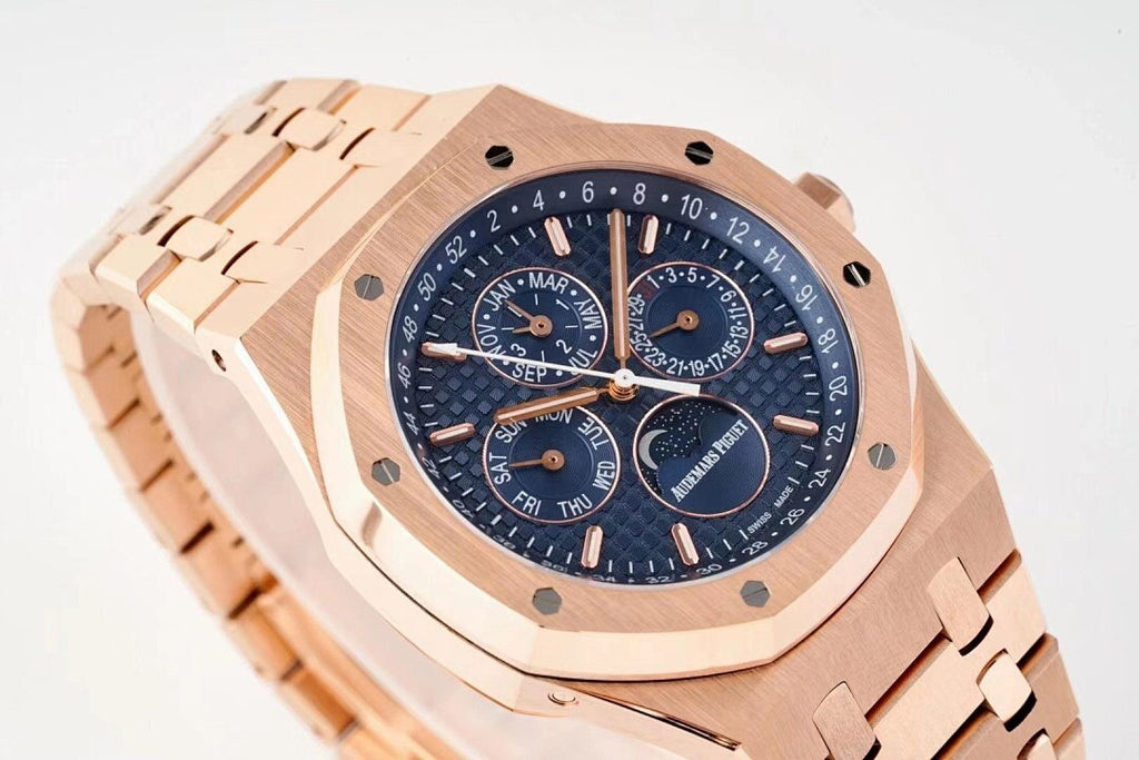 Rose gold-tone wristwatch dial close-up with blue textured center and subdial hands.