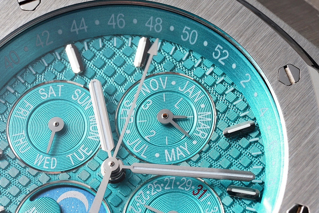 Audemars Piguet watch dial close-up with teal guilloche pattern and hour markers