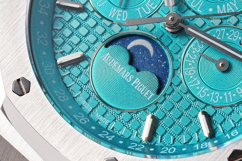 Audemars Piguet watch dial close-up with teal moon-phase display and indices
