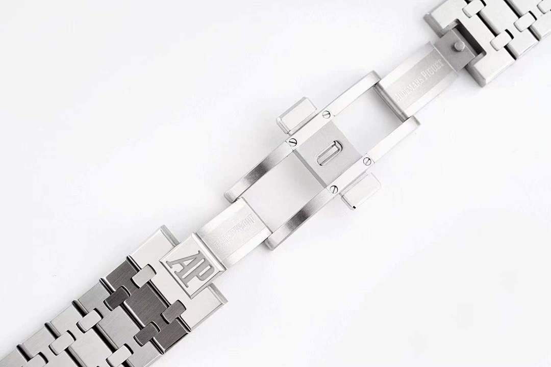 Metal watch bracelet with interlocking links and engraved logo on the clasp