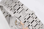Metal watch bracelet clasp with raised logo plate and polished link edges